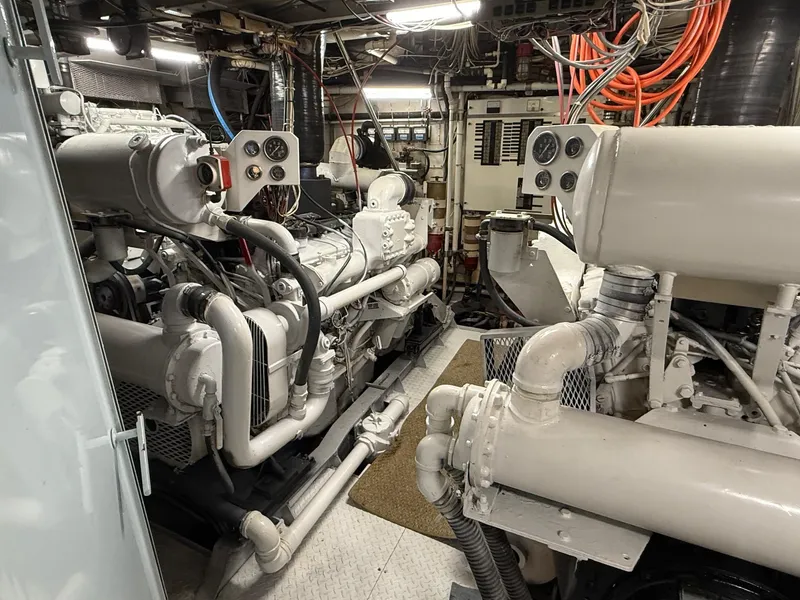 Slide: The Image of Engine room of 1972 Burger 81 Raised Pilothouse yacht, featuring complex machinery and wiring. - 23