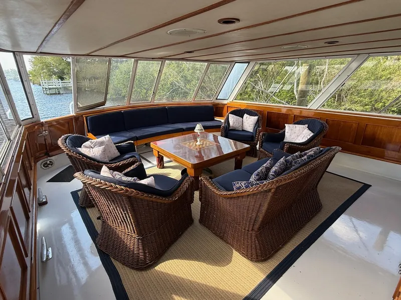 Slide: The Image of Luxurious seating area on 1972 Burger 81 Raised Pilothouse yacht with wicker furniture. - 5