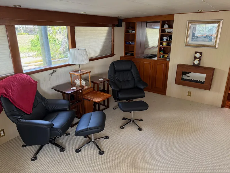 Slide: The Image of Interior of 1972 Burger 81 Raised Pilothouse with chairs, lamp, and built-in shelves. - 7