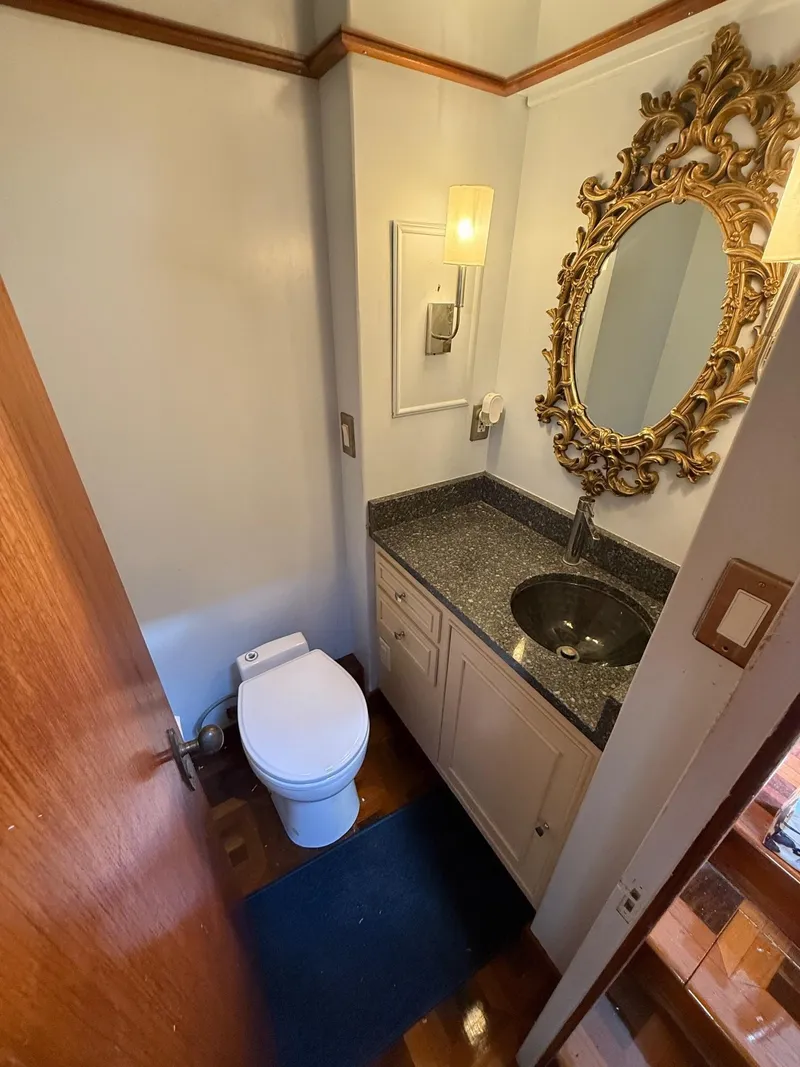 Slide: The Image of Luxurious bathroom on 1972 Burger 81 Raised Pilothouse yacht with ornate mirror and modern fixtures. - 8