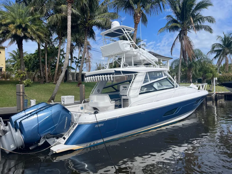 The Image of 2022 Intrepid 477 Evolution boat docked, featuring sleek design and powerful engines. - 1