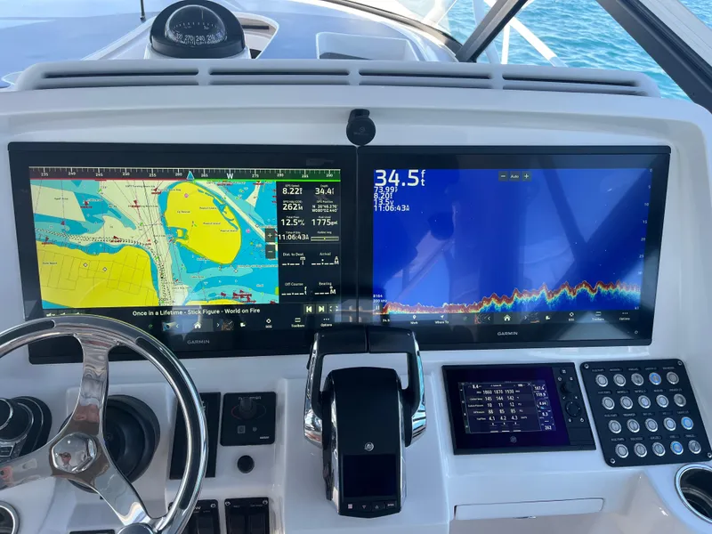 Slide: The Image of 2022 Intrepid 477 Evolution helm with dual navigation screens and steering wheel. - 10