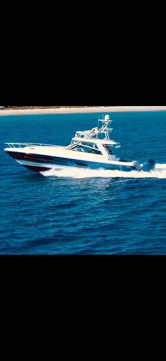 Slide: The Image of 2022 Intrepid 477 Evolution yacht cruising on open water. - 16