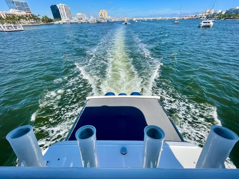 Slide: The Image of 2022 Intrepid 477 Evolution cruising on a sunny day, leaving a wake in the water. - 7