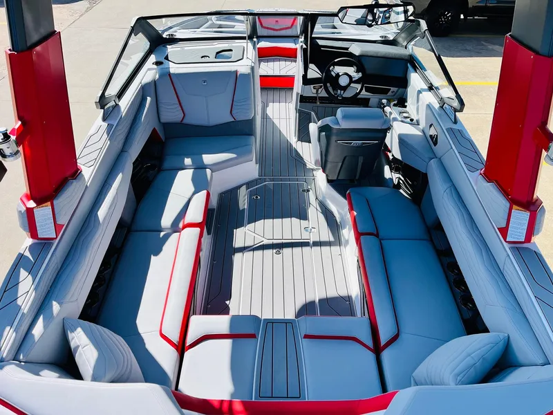 Slide: The Image of 2025 Nautique Super Air Nautique G23 interior with sleek gray and red seating. - 12