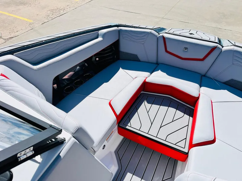 Slide: The Image of 2025 Nautique Super Air Nautique G23 interior with gray and red seating. - 14