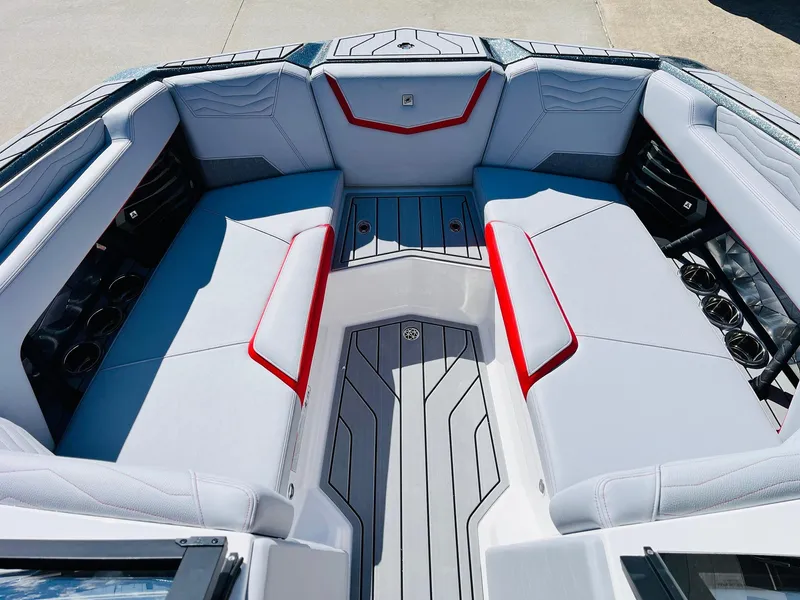 Slide: The Image of 2025 Nautique Super Air Nautique G23 interior with sleek gray and red seating design. - 19
