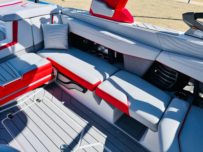 Slide: The Image of 2025 Nautique Super Air Nautique G23 interior with red and gray seating. - 27