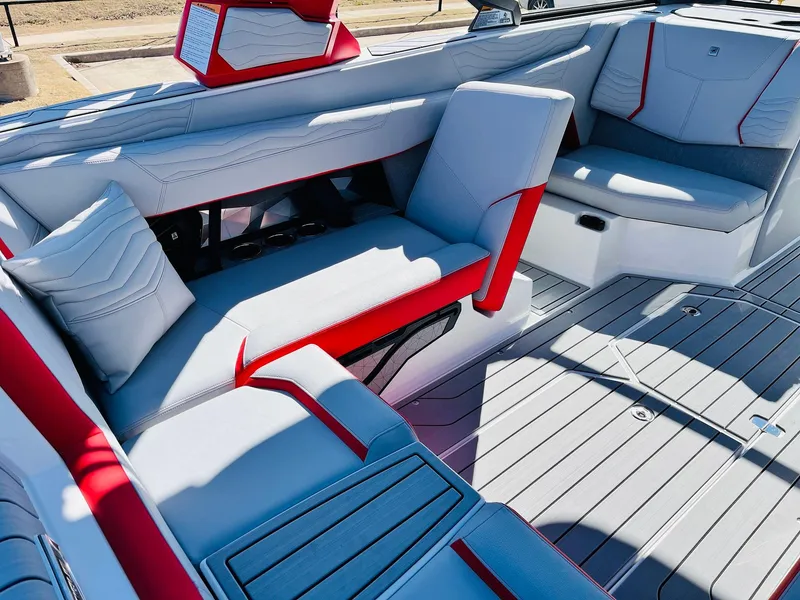 Slide: The Image of 2025 Nautique Super Air Nautique G23 interior with red and gray seating. - 29