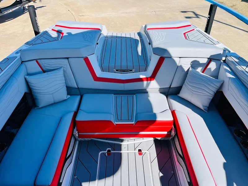Slide: The Image of 2025 Nautique Super Air Nautique G23 interior with modern seating and red accents. - 32