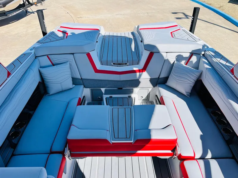 Slide: The Image of 2025 Nautique Super Air Nautique G23 interior with modern seating and red accents. - 33