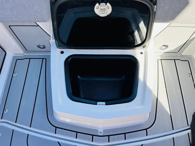 Slide: The Image of 2025 Nautique Super Air Nautique G23 storage compartment on deck. - 37