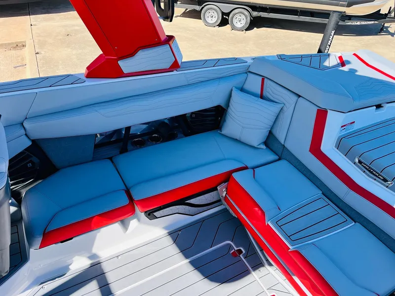Slide: The Image of 2025 Nautique Super Air Nautique G23 interior with red and gray seating. - 39