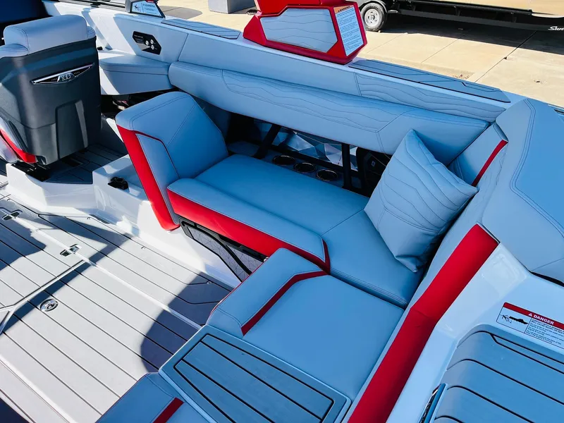 Slide: The Image of 2025 Nautique Super Air Nautique G23 interior with red and gray seating. - 42