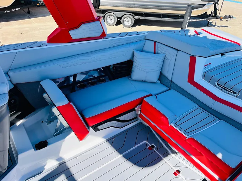 Slide: The Image of 2025 Nautique Super Air Nautique G23 interior with red and gray seating. - 43
