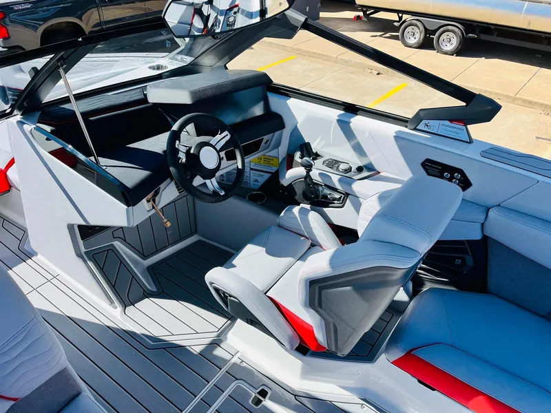 Slide: The Image of Interior of 2025 Nautique Super Air Nautique G23 boat, featuring modern steering and seating. - 44
