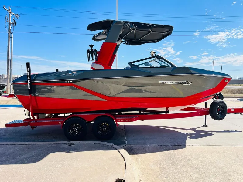 Slide: The Image of 2025 Nautique Super Air Nautique G23 boat on trailer, red and gray design. - 5