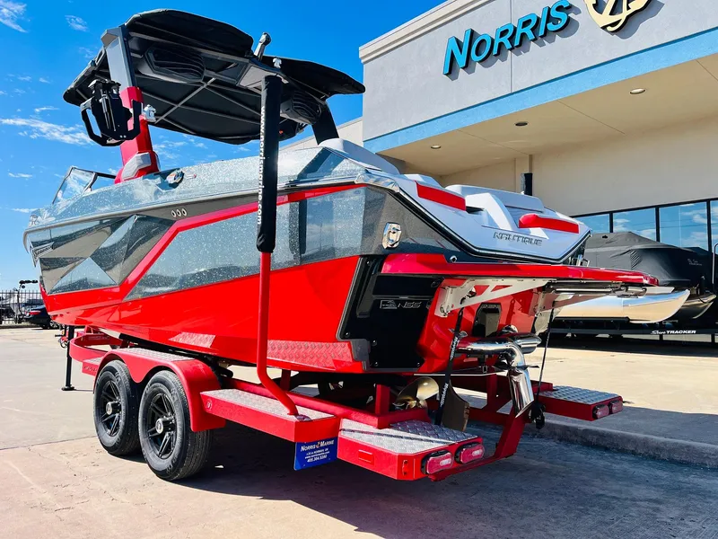 Slide: The Image of 2025 Nautique Super Air Nautique G23 boat in vibrant red on a trailer. - 8