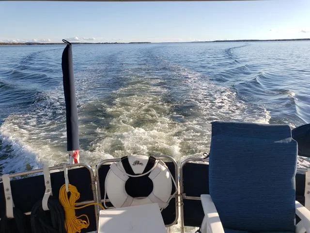 Slide: The Image of 1988 President 37 Sundeck yacht with striped chairs on deck at marina. - 15