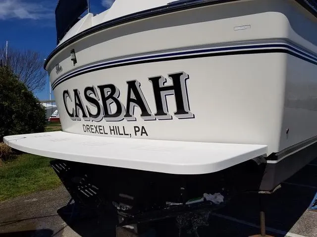 Slide: The Image of 1988 President 37 Sundeck yacht with inflatable boat on deck, docked at marina. - 19