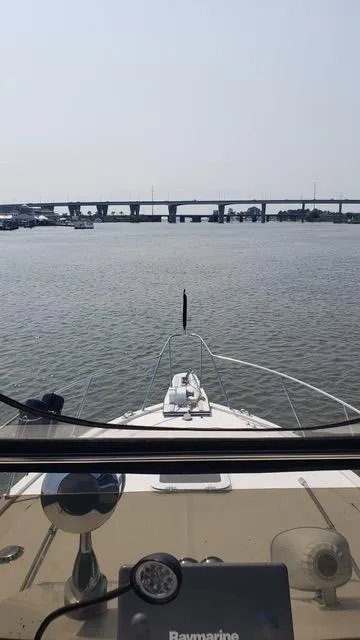 Slide: The Image of 1988 President 37 Sundeck yacht docked at marina with clear sky. - 21