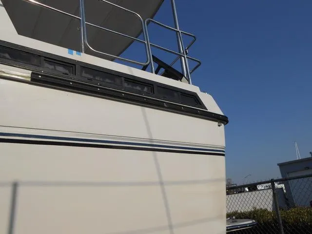 Slide: The Image of 1988 President 37 Sundeck cruising on open water, leaving a wake behind. - 22