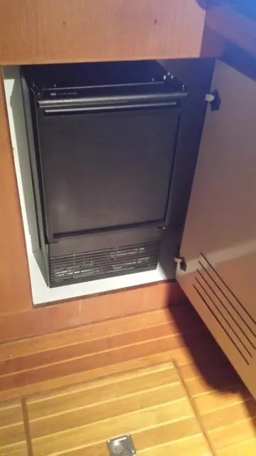 Slide: The Image of 1988 President 37 Sundeck yacht interior with cozy seating, TV, and wooden accents. - 30