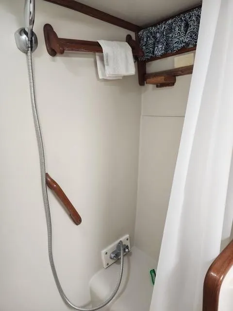 Slide: The Image of 1988 President 37 Sundeck interior with wood finish, dining area, and nautical decor. - 31