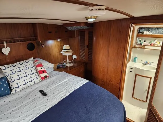 Slide: The Image of Cozy seating area in 1988 President 37 Sundeck yacht with patterned cushions and throw blanket. - 32
