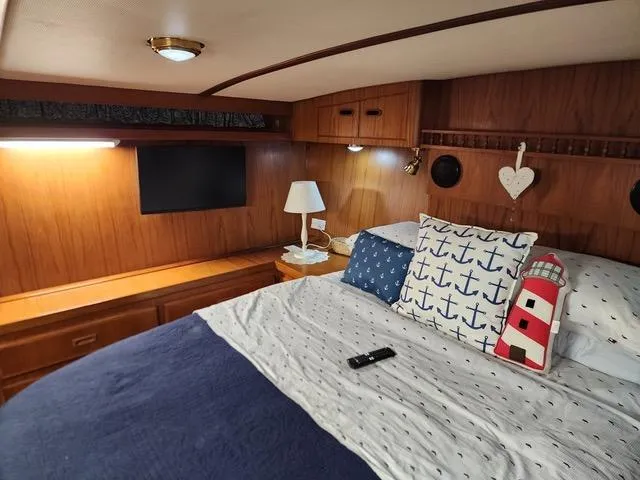 Slide: The Image of Cozy interior of 1988 President 37 Sundeck yacht with patterned sofa and TV. - 33