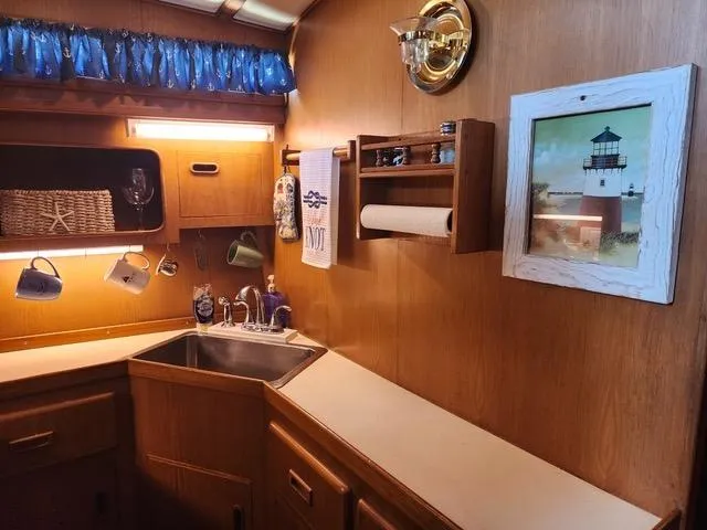 Slide: The Image of Interior of 1988 President 37 Sundeck yacht with cozy seating and wooden decor. - 35