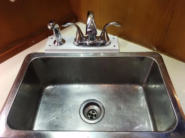 Slide: The Image of 1988 President 37 Sundeck interior with wooden table and anchor-patterned seating. - 37