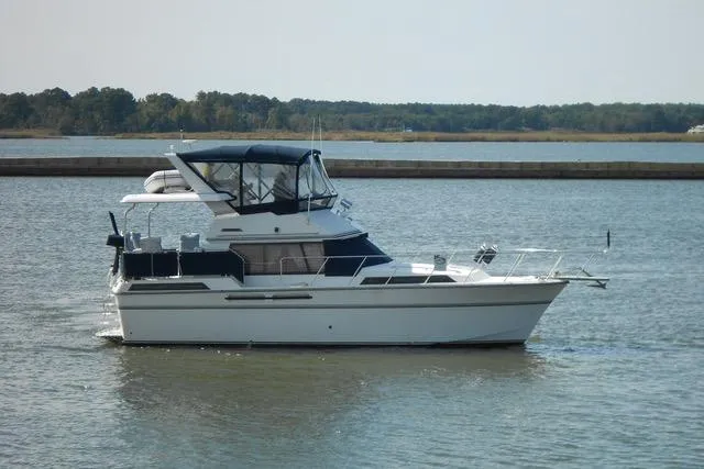 Slide: The Image of 1988 President 37 Sundeck yacht on calm water, featuring a sleek design and spacious deck. - 4