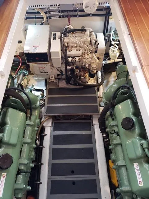 Slide: The Image of 1988 President 37 Sundeck yacht kitchen with fridge, stove, and wooden cabinetry. - 47