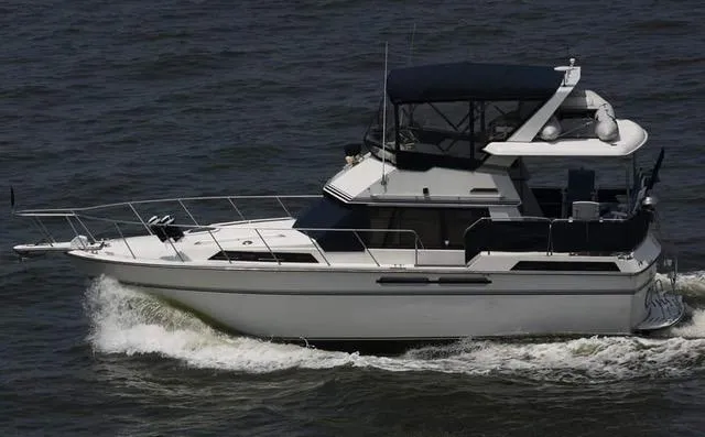 Slide: The Image of 1988 President 37 Sundeck yacht cruising on open water. - 5