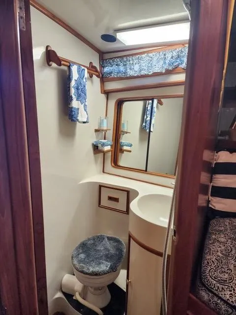 Slide: The Image of 1988 President 37 Sundeck yacht bathroom with blue accents and wooden trim. - 53