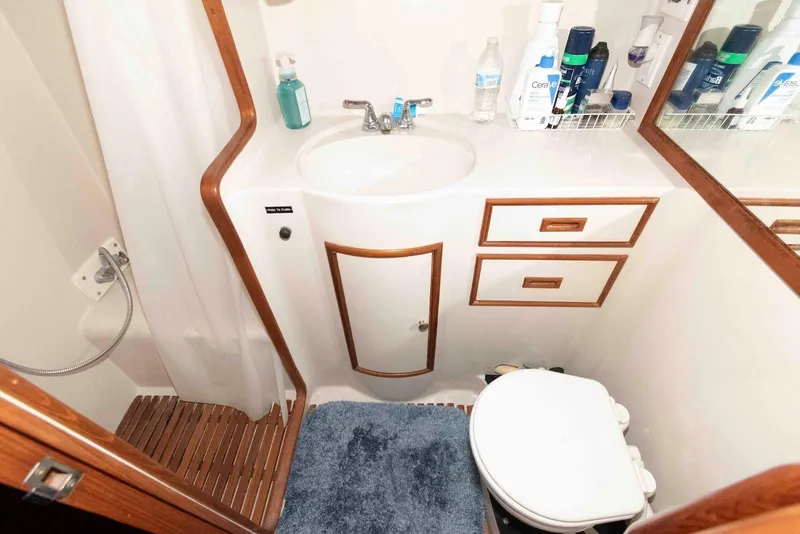 Slide: The Image of 1988 President 37 Sundeck yacht bathroom with sink, toilet, and toiletries. - 54