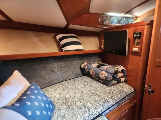 Slide: The Image of Cozy cabin interior of 1988 President 37 Sundeck with bedding and TV. - 59