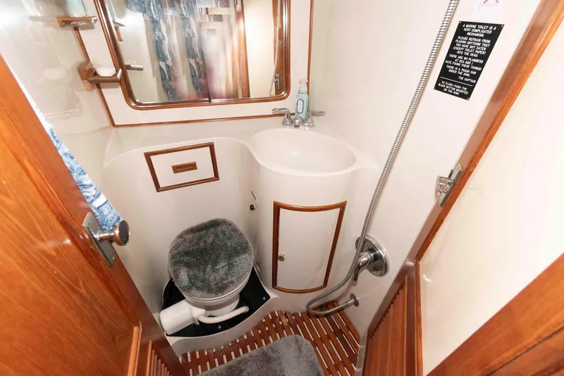 Slide: The Image of Compact bathroom in 1988 President 37 Sundeck yacht with toilet, sink, and shower. - 60