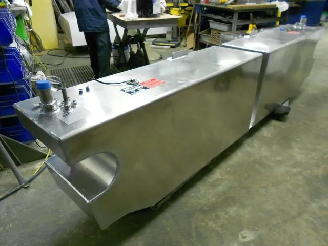 Slide: The Image of 1988 President 37 Sundeck boat fuel tanks in a workshop setting. - 64