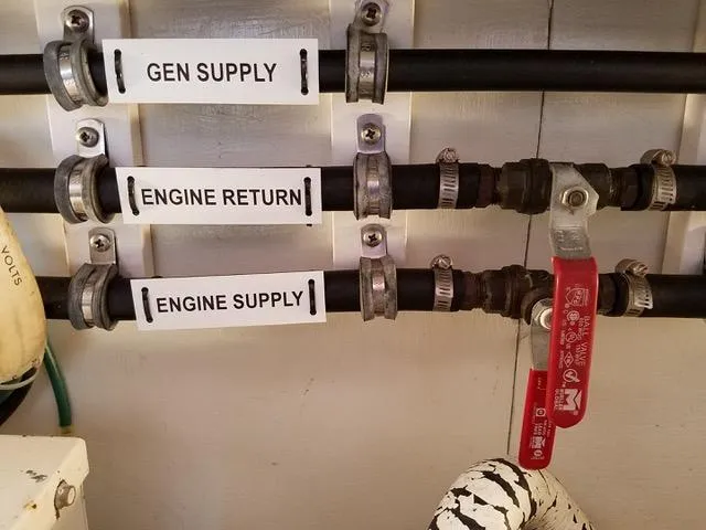 Slide: The Image of Labeled pipes on a 1988 President 37 Sundeck boat, showing gen supply, engine return, and engine supply. - 66