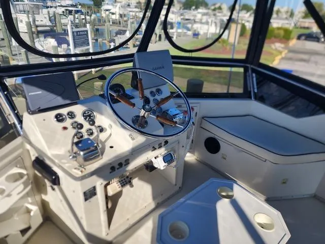 Slide: The Image of Interior view of 1988 President 37 Sundeck yacht cockpit with steering wheel and controls. - 9