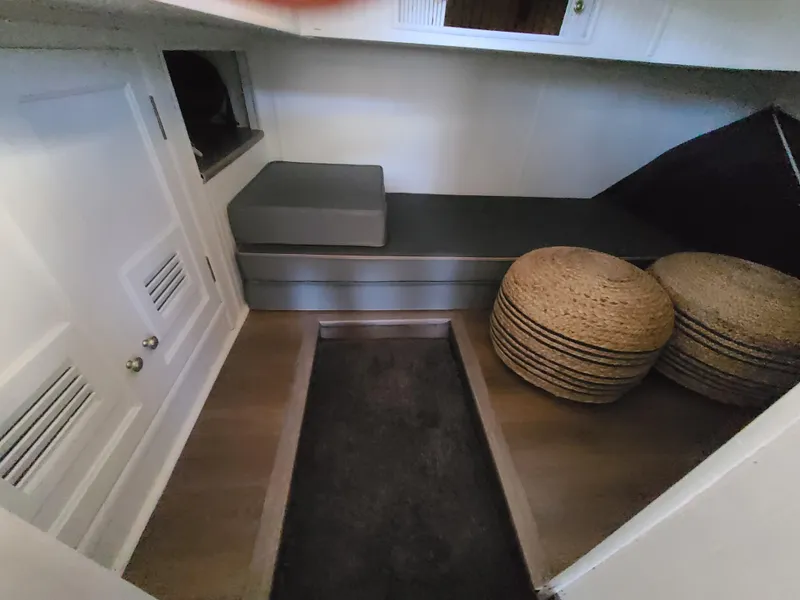 Slide: The Image of Cozy interior of a 1993 Gibson SPORT SERIES boat with seating and storage. - 10