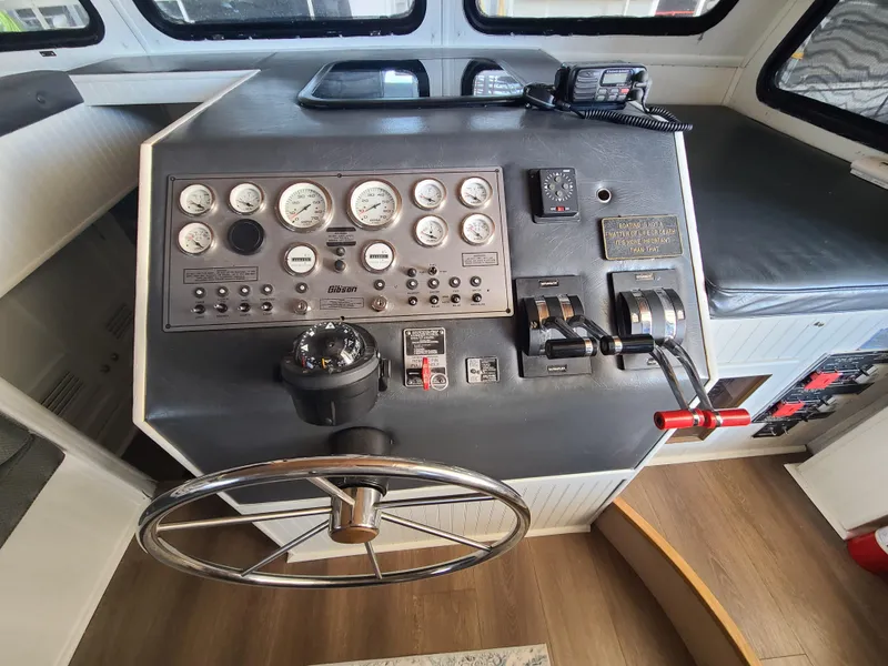 Slide: The Image of Control panel of a 1993 Gibson SPORT SERIES boat with gauges and steering wheel. - 11