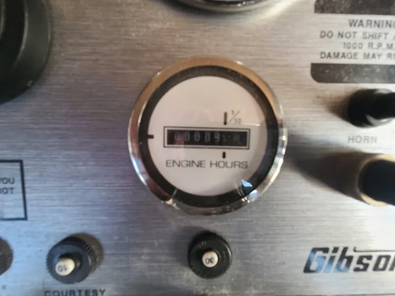 Slide: The Image of Close-up of a 1993 Gibson SPORT SERIES engine hours gauge on a control panel. - 12