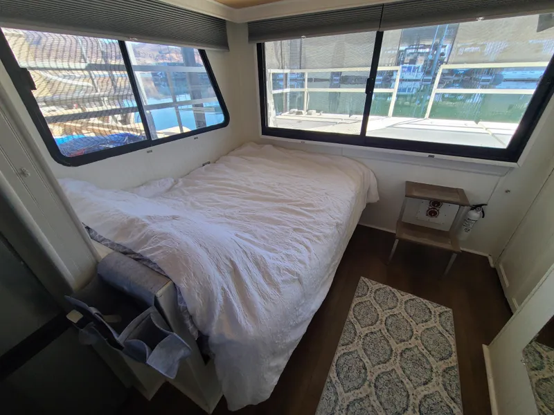 Slide: The Image of Cozy bedroom in 1993 Gibson SPORT SERIES boat with large windows and white bedding. - 15