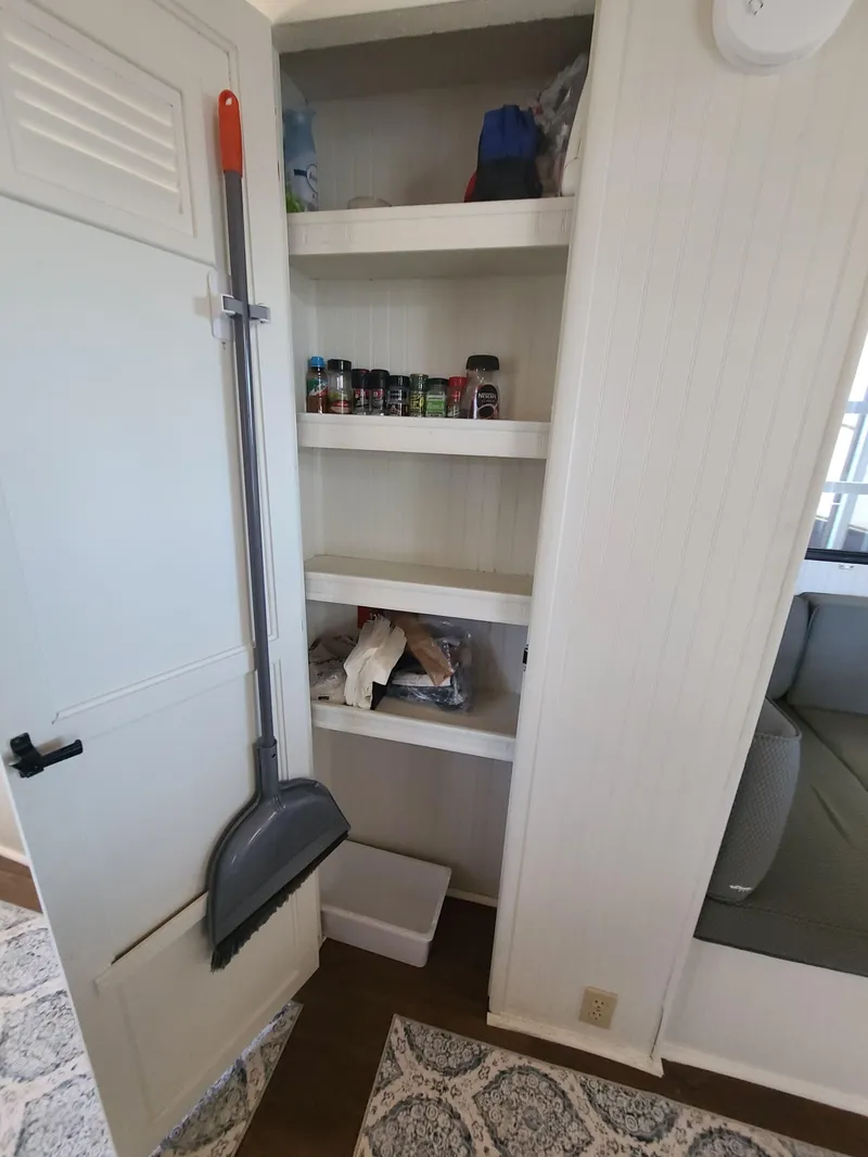 Slide: The Image of Pantry shelves with spices and cleaning supplies in a 1993 Gibson SPORT SERIES interior. - 16