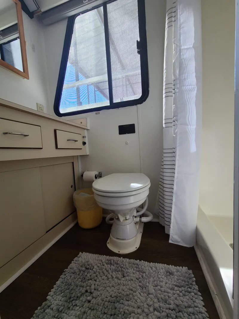 Slide: The Image of Bathroom interior of a 1993 Gibson SPORT SERIES boat, featuring a toilet and vanity. - 17