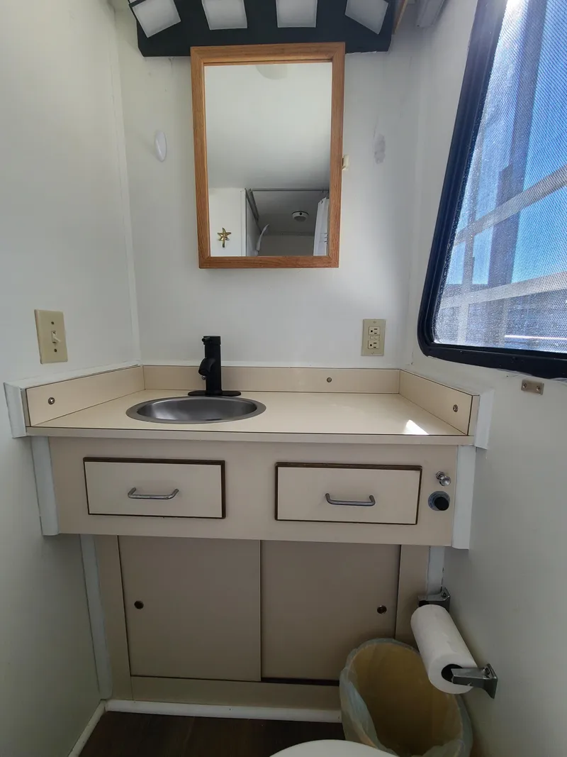 Slide: The Image of Compact bathroom in a 1993 Gibson SPORT SERIES boat with sink and mirror. - 19