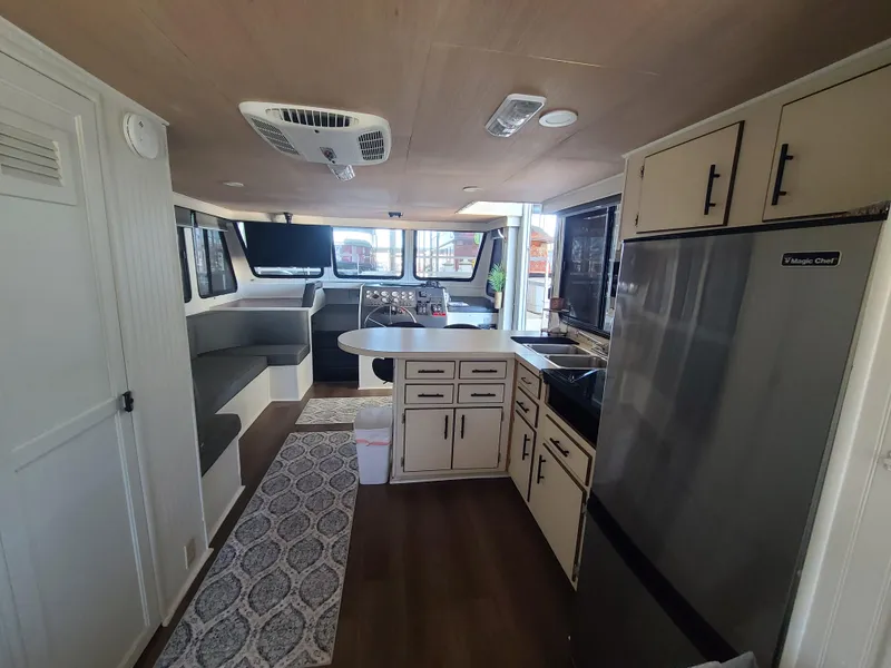 Slide: The Image of Interior of a 1993 Gibson SPORT SERIES boat with kitchen and seating area. - 21